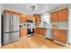 Bright kitchen with stainless steel appliances, light wood cabinets, and hardwood floors at 10301 Owens Cir, Broomfield, CO 80021