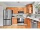 Bright kitchen with stainless steel appliances, light wood cabinets, and hardwood floors at 10301 Owens Cir, Broomfield, CO 80021