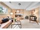 The living room has a brick fireplace, comfortable seating, and natural light at 10301 Owens Cir, Broomfield, CO 80021