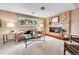 The living room features a brick fireplace and cozy seating in a bright and inviting space at 10301 Owens Cir, Broomfield, CO 80021
