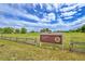 Ketner Lake open space entrance features a sign, wooden fence and grassland at 10301 Owens Cir, Broomfield, CO 80021