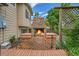 Brick outdoor fireplace and chimney on a wooden deck with a small, adjacent outdoor kitchen area at 10301 Owens Cir, Broomfield, CO 80021