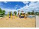 Colorful playground with slides, climbing structures, and wood chip ground covering under a partly cloudy sky at 10301 Owens Cir, Broomfield, CO 80021