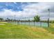 Outdoor tennis courts with green surfaces, surrounded by fencing, grass, and trees at 10301 Owens Cir, Broomfield, CO 80021