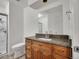 Bathroom with wood vanity, granite countertop, and tile flooring at 11535 Albion Ct, Thornton, CO 80233