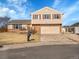 Charming split-level home featuring tan siding, brick accents, and a two-car garage at 11535 Albion Ct, Thornton, CO 80233