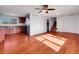 Bright living room featuring hardwood floors, white walls, and an open kitchen at 11535 Albion Ct, Thornton, CO 80233