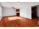 Bright living room featuring hardwood floors, white walls, and abundant sunlight at 11535 Albion Ct, Thornton, CO 80233