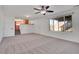 Spacious living room with a ceiling fan and window views and entrance to the Kitchen at 11535 Albion Ct, Thornton, CO 80233