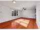 Bright living room featuring hardwood floors, white walls, and a ceiling fan at 11535 Albion Ct, Thornton, CO 80233