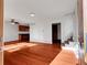 Bright living room featuring hardwood floors, white walls, and a staircase at 11535 Albion Ct, Thornton, CO 80233