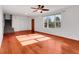 Bright living room featuring hardwood floors, white walls, and a staircase at 11535 Albion Ct, Thornton, CO 80233