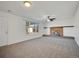 Cozy living room with a brick fireplace, neutral carpet, and large window at 11535 Albion Ct, Thornton, CO 80233