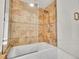 Close up view of the tiled shower-tub combo with updated fixture at 11535 Albion Ct, Thornton, CO 80233