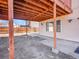 Covered patio underneath wooden deck with support beams and concrete flooring, a great space for outdoor relaxation at 11535 Albion Ct, Thornton, CO 80233