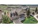 Aerial view of a home featuring a stone accent garage, porch, and well-manicured lawn at 4206 Eagle Ridge Way, Castle Rock, CO 80104