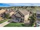 Aerial view of tan home with mountain views, lush grass, and a charming front porch at 4206 Eagle Ridge Way, Castle Rock, CO 80104