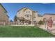Landscaped backyard features a deck, patio area, green grass, and white fence at 4206 Eagle Ridge Way, Castle Rock, CO 80104