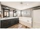 Bathroom with a dual sink vanity, soaking tub, and a glass shower, combining elegance and practicality at 4206 Eagle Ridge Way, Castle Rock, CO 80104