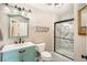 Charming bathroom features a turquoise vanity, tile flooring, and a glass-enclosed shower, offering a stylish retreat at 4206 Eagle Ridge Way, Castle Rock, CO 80104