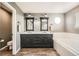 Bathroom with a dual sink vanity, soaking tub, and tile flooring, providing a luxurious and functional space at 4206 Eagle Ridge Way, Castle Rock, CO 80104