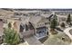 Charming tan two-story home featuring stone accents and a covered front porch at 4206 Eagle Ridge Way, Castle Rock, CO 80104