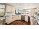 Open kitchen with white cabinets, stainless steel appliances, and hardwood floors at 4206 Eagle Ridge Way, Castle Rock, CO 80104