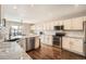 Spacious kitchen with white cabinets, stainless steel appliances, granite countertops, and hardwood floors at 4206 Eagle Ridge Way, Castle Rock, CO 80104