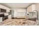 Bright kitchen featuring white cabinets, stainless steel appliances, and a granite countertop island at 4206 Eagle Ridge Way, Castle Rock, CO 80104