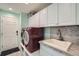 Laundry room with mosaic tile backsplash and front loading washer and dryer at 4206 Eagle Ridge Way, Castle Rock, CO 80104