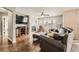 Inviting living room with a fireplace, a dark leather sofa set, wood floors, and ample natural light at 4206 Eagle Ridge Way, Castle Rock, CO 80104