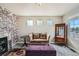 Cozy living room featuring a brick accent wall, decorative fireplace, and stylish furniture at 4206 Eagle Ridge Way, Castle Rock, CO 80104