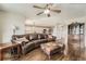 Living room showcases hardwood floors, ceiling fan, and decorative furniture, with a partial view into the kitchen at 4206 Eagle Ridge Way, Castle Rock, CO 80104