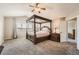 The main bedroom boasts a four-poster bed, soft carpet, and natural light, creating a serene and inviting ambiance at 4206 Eagle Ridge Way, Castle Rock, CO 80104