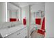 Bright bathroom features white cabinets, modern fixtures, and marble countertops at 12286 W Tennessee, Lakewood, CO 80228