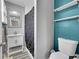 Contemporary bathroom with patterned shower curtain, white shelves, and vanity at 12286 W Tennessee, Lakewood, CO 80228