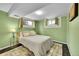 Cozy bedroom with green walls, natural light, and plush area rug at 12286 W Tennessee, Lakewood, CO 80228
