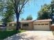 Charming single-story home featuring a well-maintained lawn and an attached two-car garage at 12286 W Tennessee, Lakewood, CO 80228