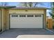 Attached garage showcasing a well-maintained door with windows and updated exterior paint at 12286 W Tennessee, Lakewood, CO 80228