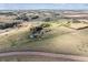 An aerial view of a sprawling landscape with scattered homes at 371 Buckskin Ct, Parker, CO 80138