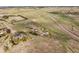 Acreage aerial view highlights homes with mature trees and expansive grass lands at 371 Buckskin Ct, Parker, CO 80138