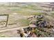 Expansive aerial view showcases acreage with mature trees surrounding the homes at 371 Buckskin Ct, Parker, CO 80138