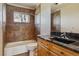 Tiled bathroom with granite countertop, vanity, and shower-tub combination at 371 Buckskin Ct, Parker, CO 80138