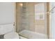 Bathroom featuring glass-enclosed shower, ceramic tile surround, and convenient toilet placement at 371 Buckskin Ct, Parker, CO 80138