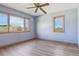 Bright bedroom features hardwood floors and large windows with scenic views at 371 Buckskin Ct, Parker, CO 80138
