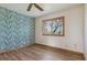 Cozy bedroom with hardwood floors and a decorative accent wall at 371 Buckskin Ct, Parker, CO 80138