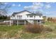 A charming two-story home with white exterior and multiple decks offers scenic views of the surrounding landscape at 371 Buckskin Ct, Parker, CO 80138