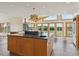 Open-concept kitchen with spacious center island, natural wood cabinets, and large windows offering panoramic views at 371 Buckskin Ct, Parker, CO 80138