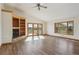 Open living room featuring a fireplace with built-in shelving, hardwood floors, and large windows for natural light at 371 Buckskin Ct, Parker, CO 80138