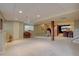 Finished basement with carpet, drop ceiling, and an open layout with columns at 24556 E Ottawa Ave, Aurora, CO 80016